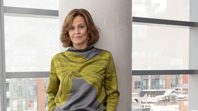 Sigourney Weaver leaning on a pillar