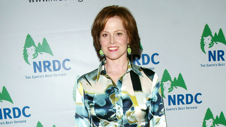 Sigourney Weaver smiling in a multicolored shirt