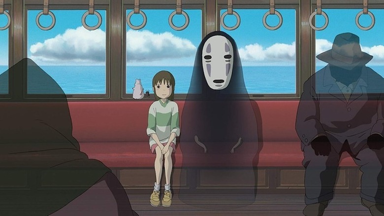 Chihiro and No-Face sitting on train 