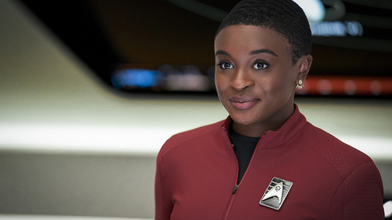 Uhura smiles on the bridge