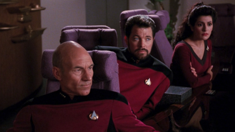 Picard, Riker, and Troi in meeting