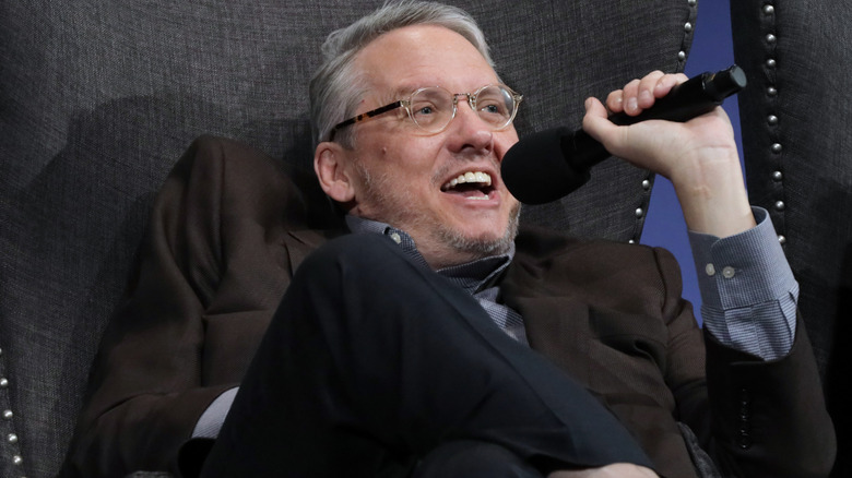 Adam McKay smiling with microphone