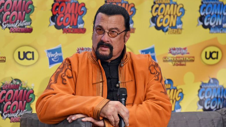 Steven Seagal with sunglasses on looking upset