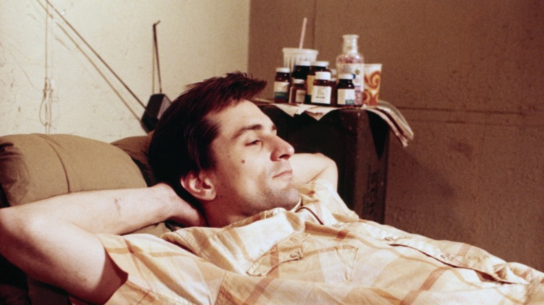 Robert De Niro relaxing on a sofa