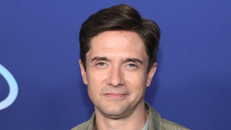 Topher Grace smirking