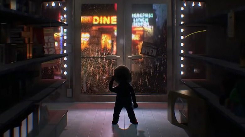 Chucky standing in dark store