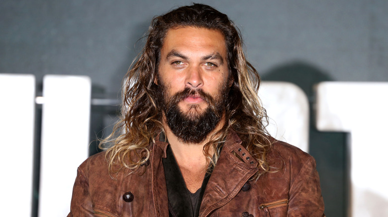 Jason Momoa wearing a brown jacket