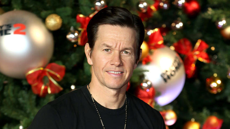 Mark Wahlberg in front of a Christmas tree