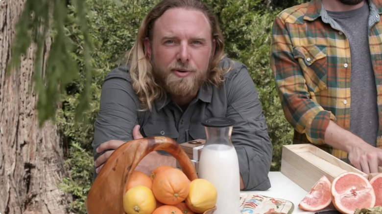 James Schrader leans over food