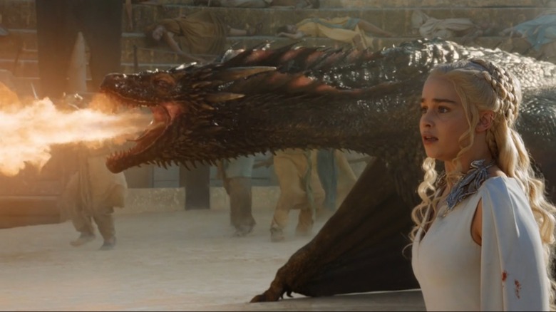 Drogon breathing fire as Daenerys watches