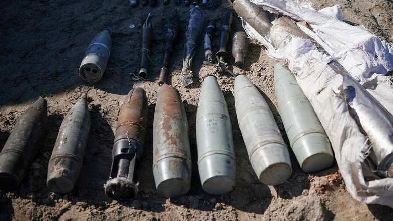 Explosives lined up on dirt