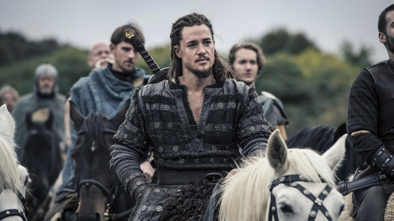 Uhtred on white horse, smirking