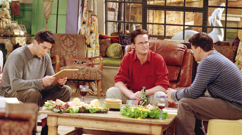 Ross, Chandler and Joey talk in the living room