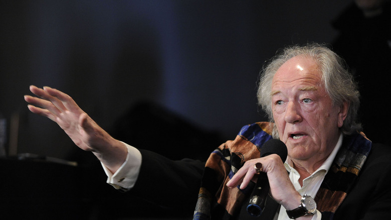 Michael Gambon speaking into mic