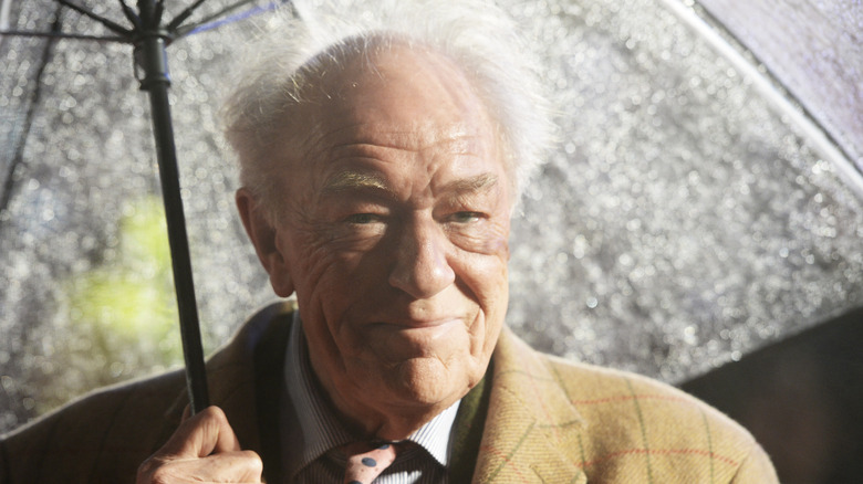 Michael Gambon with umbrella