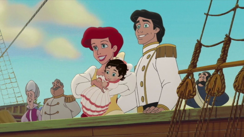 Ariel and Eric hold baby