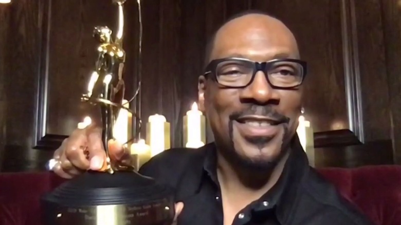 Eddie Murphy holding an award