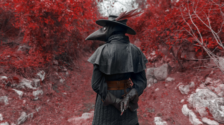 plague doctor strolling through woods