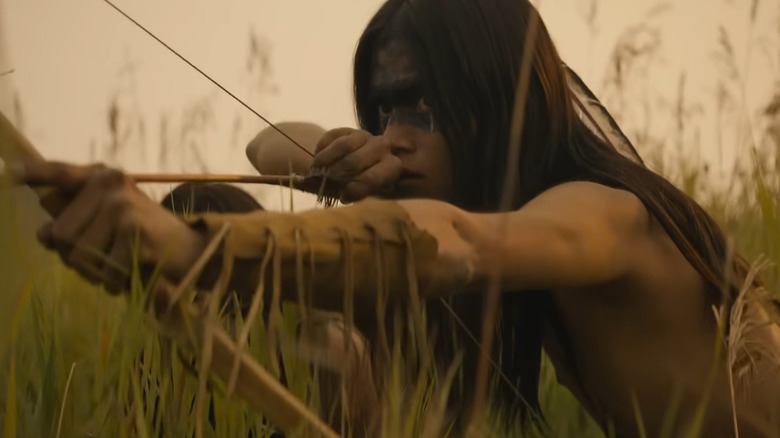 A Comanche warrior holding a bow and arrow