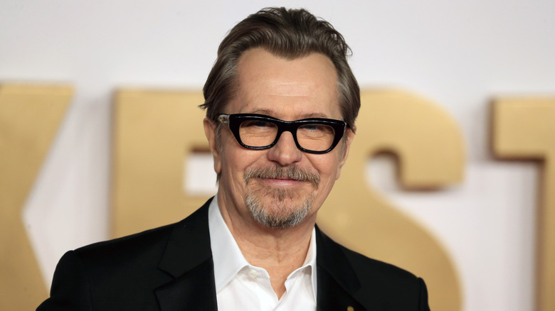 A bespectacled Gary Oldman smiling