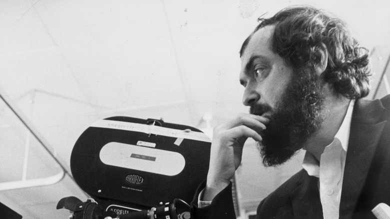 Stanley Kubrick stands next to camera