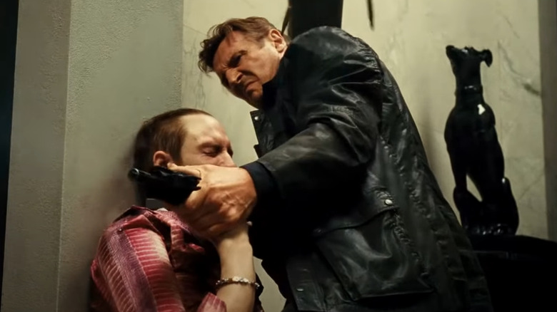 Liam Neeson firing a gun