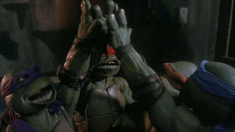 TMNT high-five and say Cowabunga