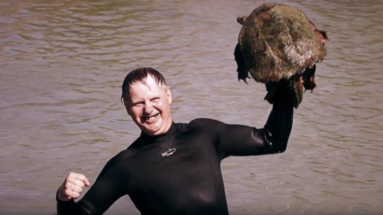 Turtleman holds a turtle