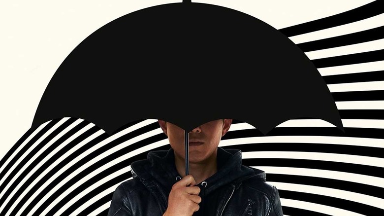 Ben in a promotional photo with an umbrella