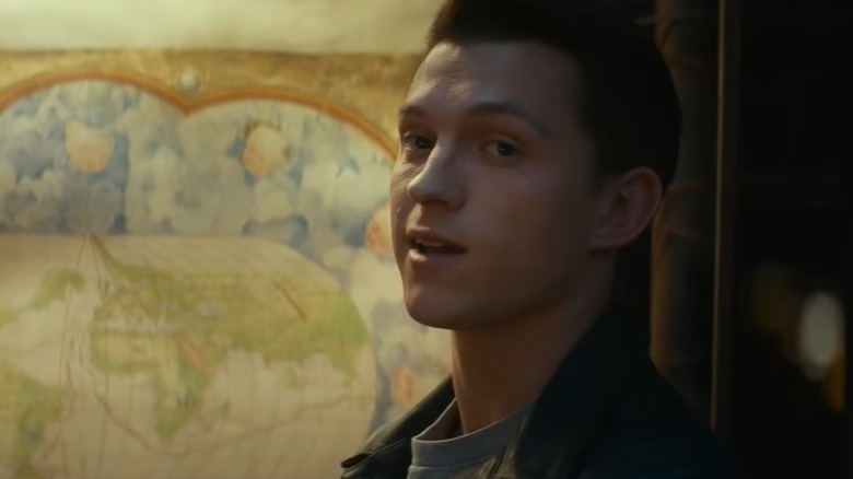 Tom Holland looking over a map for clues Uncharted