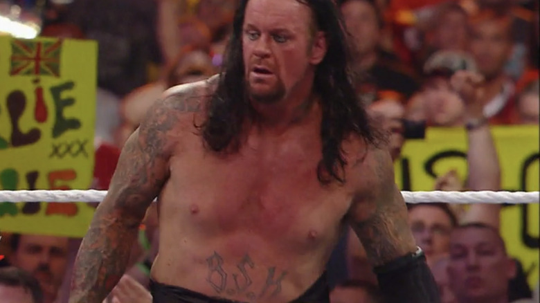 The Undertaker shows off his Bone Street Krew tattoo at Wrestlemania 26