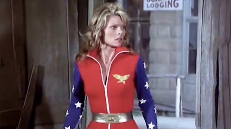 Cathy Lee Crosby stands in front of broken doorway