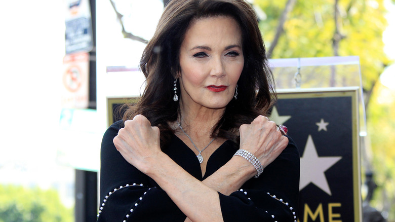 Lynda Carter posing with arms in an X