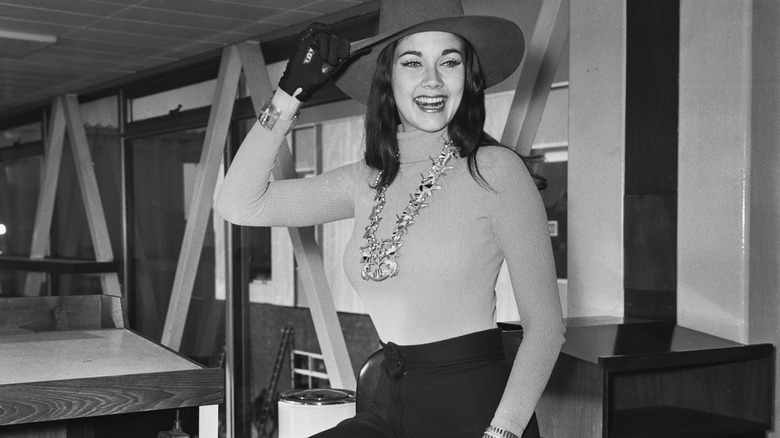 Young Lynda Carter stands in office