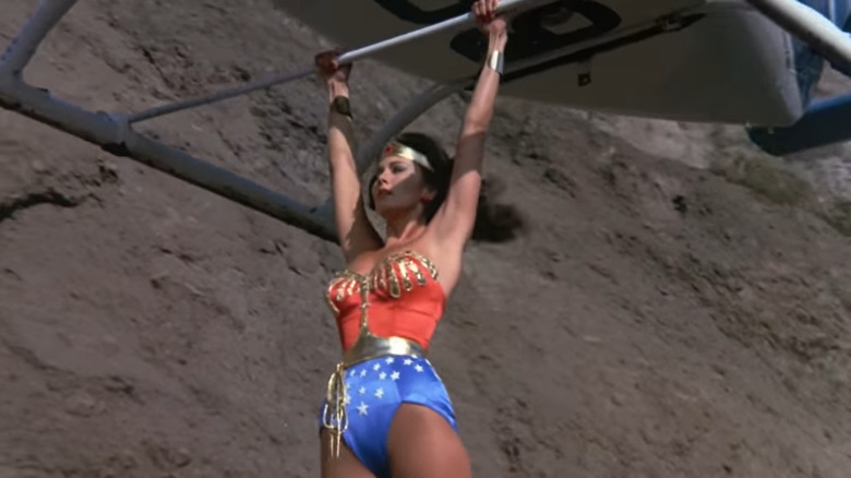 Wonder Woman grabs on to the helicopter