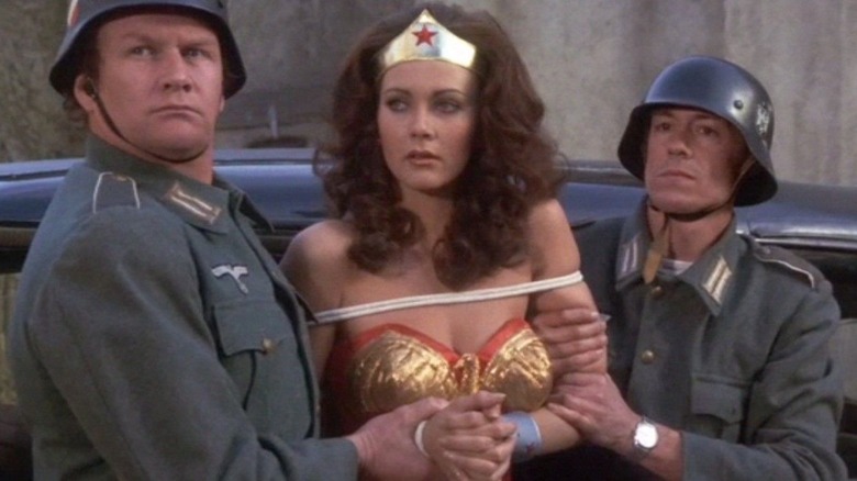 Wonder Woman and officers in front of car 