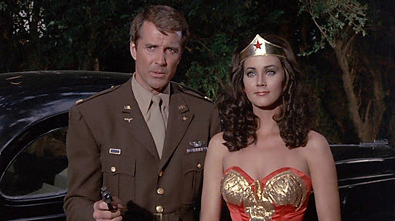 Steve Trevor and Wonder Woman stand in front of car