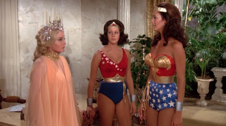 Diana, Drusilla, and woman stand in marbled room