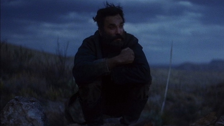 Daniel Plainview huddled alone