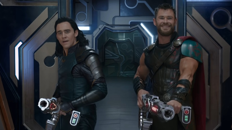 Loki and Thor holding weapons