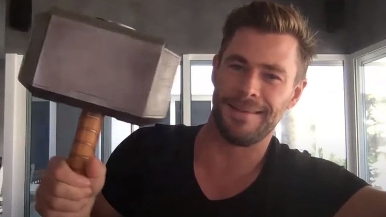 Chris Hemsworth holding a hammer prop