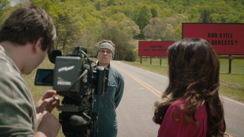 McDormand in front of billboards