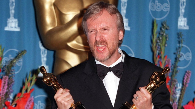 James Cameron holding Oscars