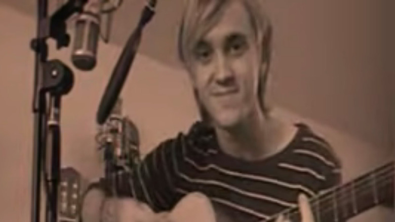 Tom Felton playing guitar