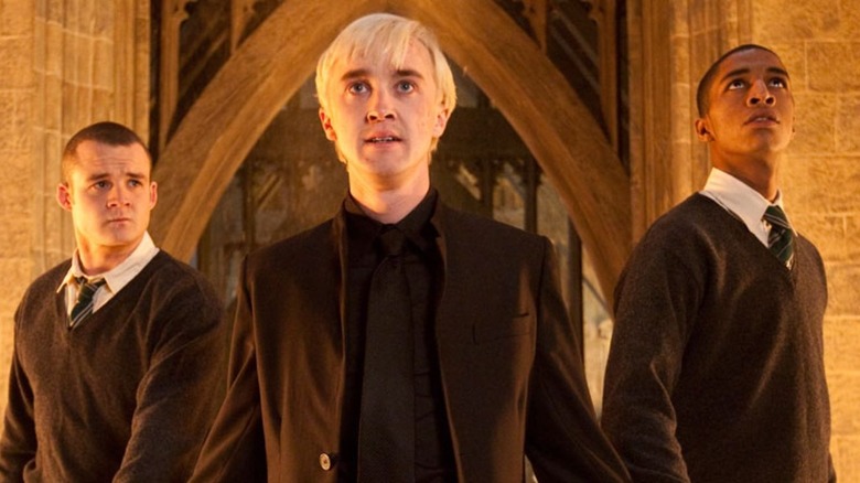 Draco standing with two friends