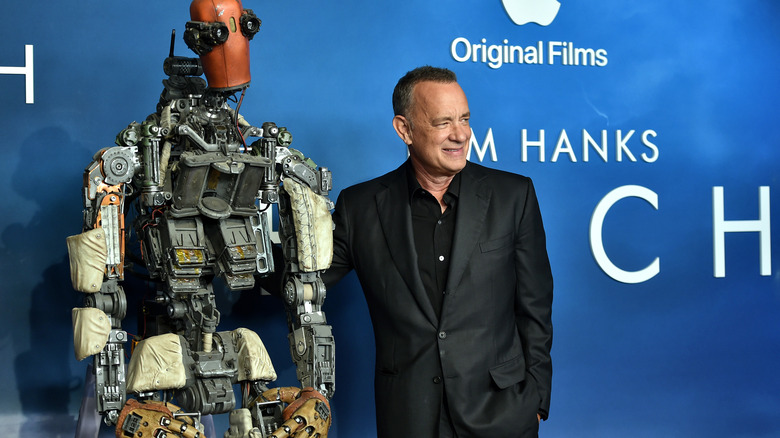 Tom Hanks poses with a robot