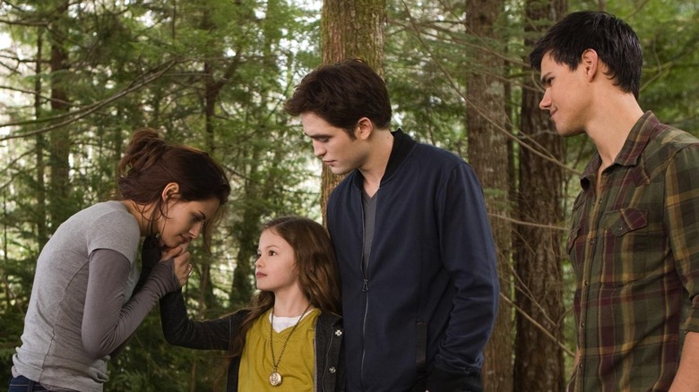 Bella, Renesmee, Edward, and Jacob in the forest