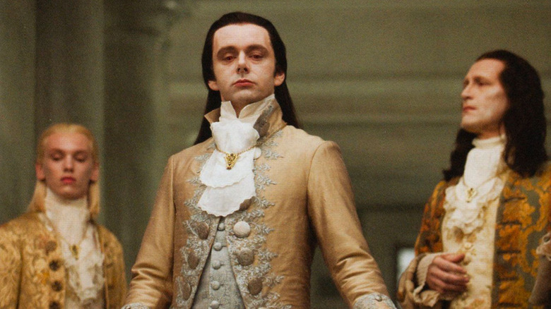 Caius, Aro, and Marcus in elegant gold coats