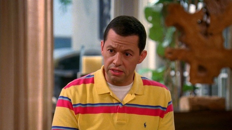 Alan Harper wearing a yellow, red and blue striped shirt