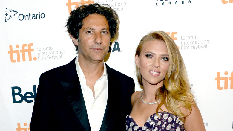 Scarlett Johansson smiles next to Jonathan Glazer